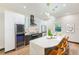 Modern kitchen with white and dark cabinets, marble countertops, and stainless steel appliances at 4008 W Leila Ave, Tampa, FL 33616