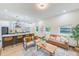 Open concept living and kitchen area with leather sofa and modern decor at 4008 W Leila Ave, Tampa, FL 33616
