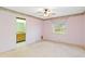 Simple bedroom with a window, ceiling fan and carpet flooring at 7853 Sundown Dr, St Petersburg, FL 33709