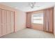 Bedroom with light pink walls, carpet flooring, and built in closet at 7853 Sundown Dr, St Petersburg, FL 33709