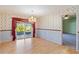 Dining room with hardwood floors, slider to screened patio and a chandelier at 7853 Sundown Dr, St Petersburg, FL 33709