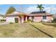 Pink house with solar panels and a spacious yard at 7853 Sundown Dr, St Petersburg, FL 33709