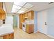 Kitchen with wood cabinets and a light-colored countertop at 7853 Sundown Dr, St Petersburg, FL 33709