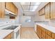 Kitchen with wood cabinets and white appliances at 7853 Sundown Dr, St Petersburg, FL 33709