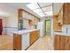 Kitchen with wood cabinets, light countertops, and a dishwasher at 7853 Sundown Dr, St Petersburg, FL 33709