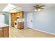 Bright kitchen features wood cabinets, laminate flooring and an electric range at 7853 Sundown Dr, St Petersburg, FL 33709