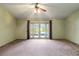 Spacious carpeted main bedroom with sliding glass doors leading to the pool area at 7853 Sundown Dr, St Petersburg, FL 33709