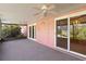 Cozy screened patio with ceiling fan and access to the backyard at 7853 Sundown Dr, St Petersburg, FL 33709