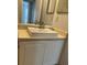 Bathroom vanity with single sink, neutral countertop and white cabinets at 10024 Strafford Oak Ct # 815, Tampa, FL 33624