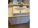 Bathroom vanity with a single sink, neutral countertop and white cabinets at 10024 Strafford Oak Ct # 815, Tampa, FL 33624