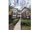 Two-story condo building with brick and siding exterior, landscaping, and walkway at 10024 Strafford Oak Ct # 815, Tampa, FL 33624