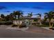 Stunning two-story home with a brick facade and palm trees at 123 8Th E St, Tierra Verde, FL 33715