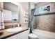 Modern bathroom with subway tile and teal shower curtain at 15304 Serengeti Blvd, Spring Hill, FL 34610