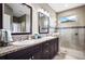Modern bathroom with double vanity, granite countertops, and shower at 15304 Serengeti Blvd, Spring Hill, FL 34610