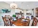 Elegant dining room with a large wooden table and kitchen views at 15304 Serengeti Blvd, Spring Hill, FL 34610