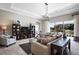 Spacious living room with large windows, neutral decor, and access to backyard at 15304 Serengeti Blvd, Spring Hill, FL 34610