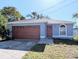 Newly constructed light blue home with a two-car garage and a well-manicured lawn at 2060 6Th St, Sarasota, FL 34237