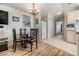 Dining area features a table, four chairs, and open view to kitchen at 3836 Chris Dr, Wesley Chapel, FL 33543