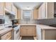 Galley style kitchen with white appliances and light wood cabinets at 3836 Chris Dr, Wesley Chapel, FL 33543