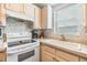Kitchen features white appliances and light wood cabinets at 3836 Chris Dr, Wesley Chapel, FL 33543