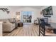 Living room with sofa, dining table, and large TV at 3836 Chris Dr, Wesley Chapel, FL 33543