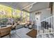 Relaxing screened porch with seating and ceiling fan at 3836 Chris Dr, Wesley Chapel, FL 33543