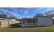 Newly built home with covered patio, fenced backyard, and grassy lawn at 1722 St Croix Dr, Clearwater, FL 33759
