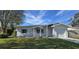 Charming house with newly landscaped lawn, attached garage, and light colored walls at 1722 St Croix Dr, Clearwater, FL 33759