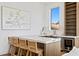Wet bar area with marble countertops, barstool seating, custom cabinetry, and a wine refrigerator at 1940 Hawaii Ne Ave, St Petersburg, FL 33703