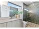 Bathroom with a large glass shower, modern gray tile, and a bright window at 1940 Hawaii Ne Ave, St Petersburg, FL 33703