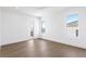 Bright bedroom with hardwood floors and a large window overlooking the neighborhood at 1940 Hawaii Ne Ave, St Petersburg, FL 33703
