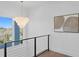 This staircase landing features a modern chandelier, a neutral piece of art, and sleek black railings at 1940 Hawaii Ne Ave, St Petersburg, FL 33703