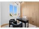 Bright home office features a modern light fixture, wood accent wall, and black furniture and decor at 1940 Hawaii Ne Ave, St Petersburg, FL 33703