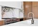 Contemporary kitchen featuring a stainless steel Wolf range and marble countertops and backsplash at 1940 Hawaii Ne Ave, St Petersburg, FL 33703
