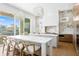 Contemporary kitchen featuring sleek countertops, modern lighting, and a breakfast bar with waterfront view at 1940 Hawaii Ne Ave, St Petersburg, FL 33703
