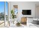 Modern living room showcasing a TV, stylish furniture, and beautiful views of the outdoor swimming pool at 1940 Hawaii Ne Ave, St Petersburg, FL 33703