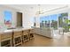 Open-concept living area with an island, breakfast bar, large windows, and a waterfront view at 1940 Hawaii Ne Ave, St Petersburg, FL 33703