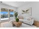 Living room features a large sliding glass door, neutral furniture, and a modern art piece at 1940 Hawaii Ne Ave, St Petersburg, FL 33703