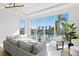 Bright living room featuring large windows, a modern gray sectional sofa, and waterfront views at 1940 Hawaii Ne Ave, St Petersburg, FL 33703