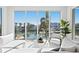 Bright living room featuring large windows, a modern white sectional sofa, and waterfront views at 1940 Hawaii Ne Ave, St Petersburg, FL 33703