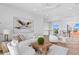Bright open-concept living room with neutral furniture, hardwood floors, and a unique chandelier at 1940 Hawaii Ne Ave, St Petersburg, FL 33703