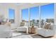 Sitting area includes white chairs with patterned pillows, an ocean view, and modern furnishings at 1940 Hawaii Ne Ave, St Petersburg, FL 33703