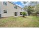 Back exterior of house with sliding glass doors and small patio at 3027 Mojave Oak Dr, Valrico, FL 33594