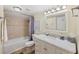 Clean bathroom with marble vanity, bathtub, and updated fixtures at 6321 Newtown Cir # 21B4, Tampa, FL 33615