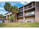 Exterior view of building with balconies and lush landscaping at 6321 Newtown Cir # 21B4, Tampa, FL 33615