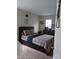 Bedroom with a dresser, and a bed with patterned bedding at 10319 Boyette Creek Blvd, Riverview, FL 33569