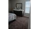 Bedroom with dresser, mirror, and patterned bedding at 10319 Boyette Creek Blvd, Riverview, FL 33569