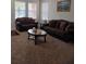 Living room featuring brown sofas, a coffee table, and carpeted floors at 10319 Boyette Creek Blvd, Riverview, FL 33569