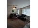Living room with black leather furniture and a view of the dining area at 10319 Boyette Creek Blvd, Riverview, FL 33569