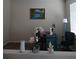 Home office with teal desk, orchid plant, and framed artwork at 10319 Boyette Creek Blvd, Riverview, FL 33569
